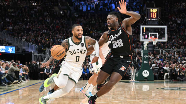 Milwaukee Bucks guard Damian Lillard dribbles to the basket against the Detroit Pistons.